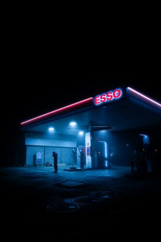 a gas station lit up at night with neon lights