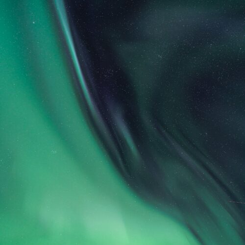 a green and black background with stars and lines